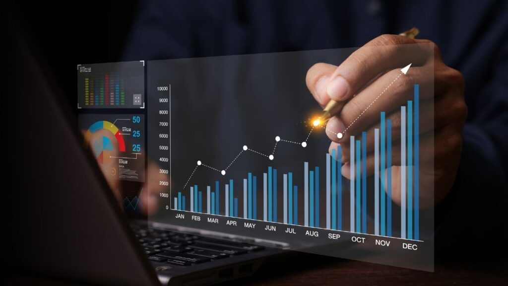 Business professional analysing upward performance charts on a digital analytics dashboard